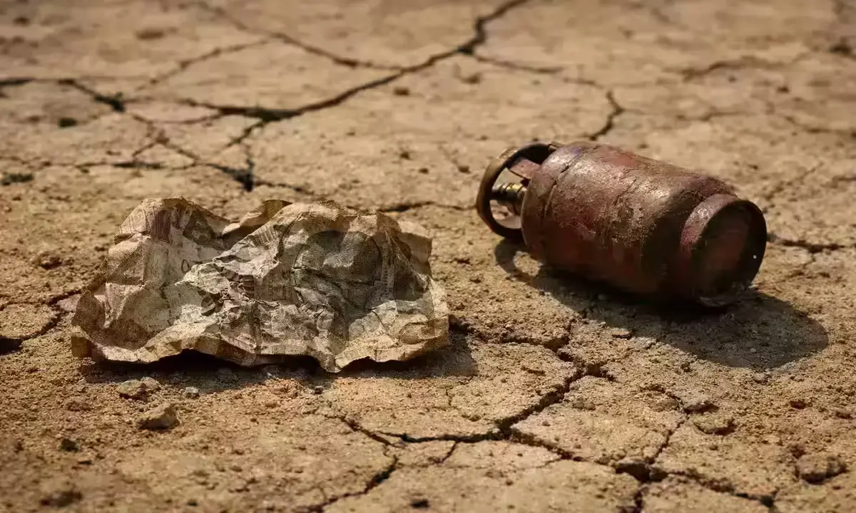 Indian rupee note and gas cylinder on cracked ground, symbolising currency fall and LPG shortage